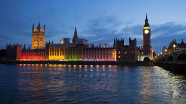 House of Commons lit up with the LGBTQ flag